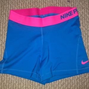Blue nike pros with pink trim